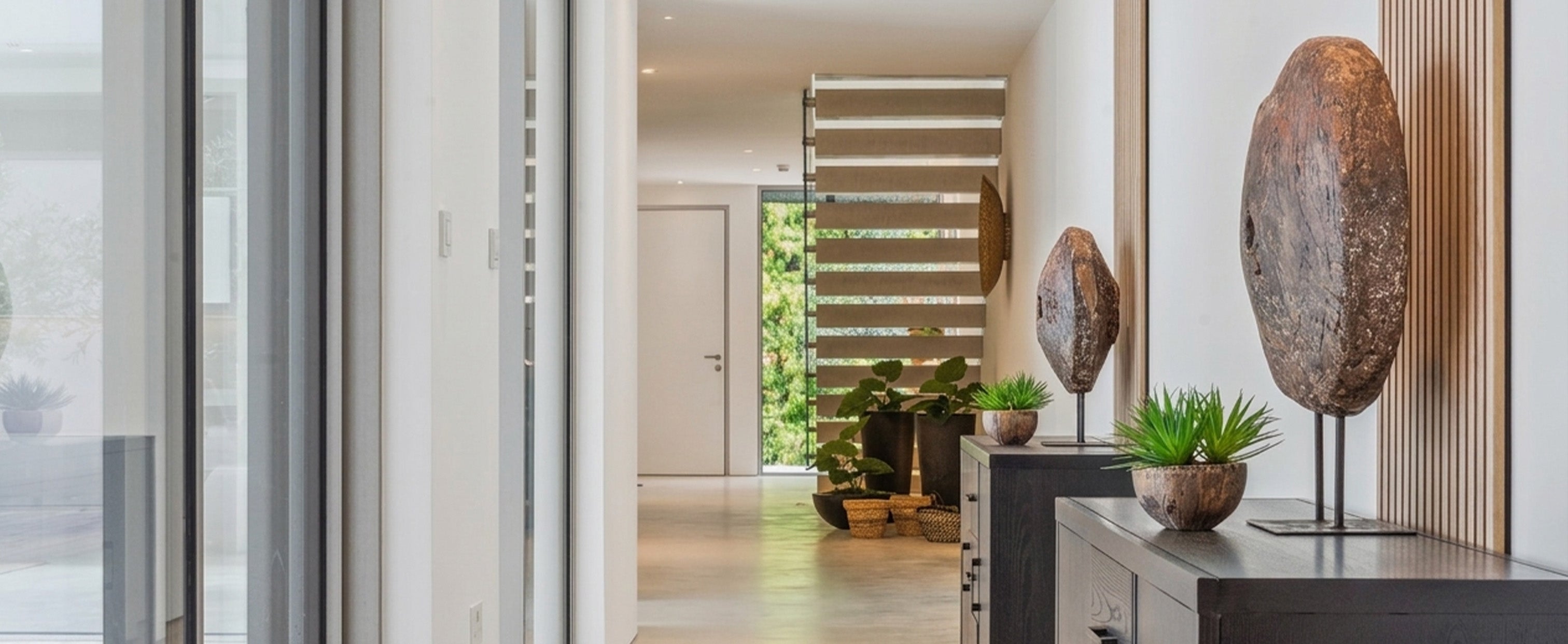 Modern residential hallway with sleek lighting, natural wood accents, and integrated AV design elements