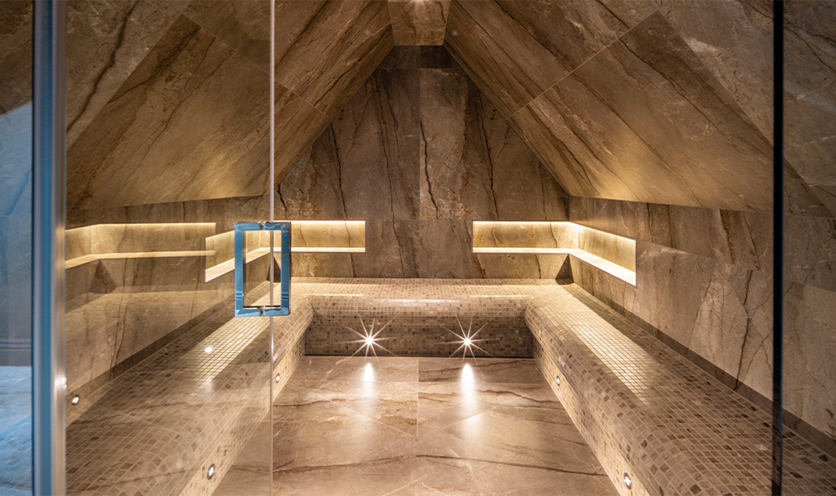 Luxury marble sauna with ambient lighting and sleek glass door design