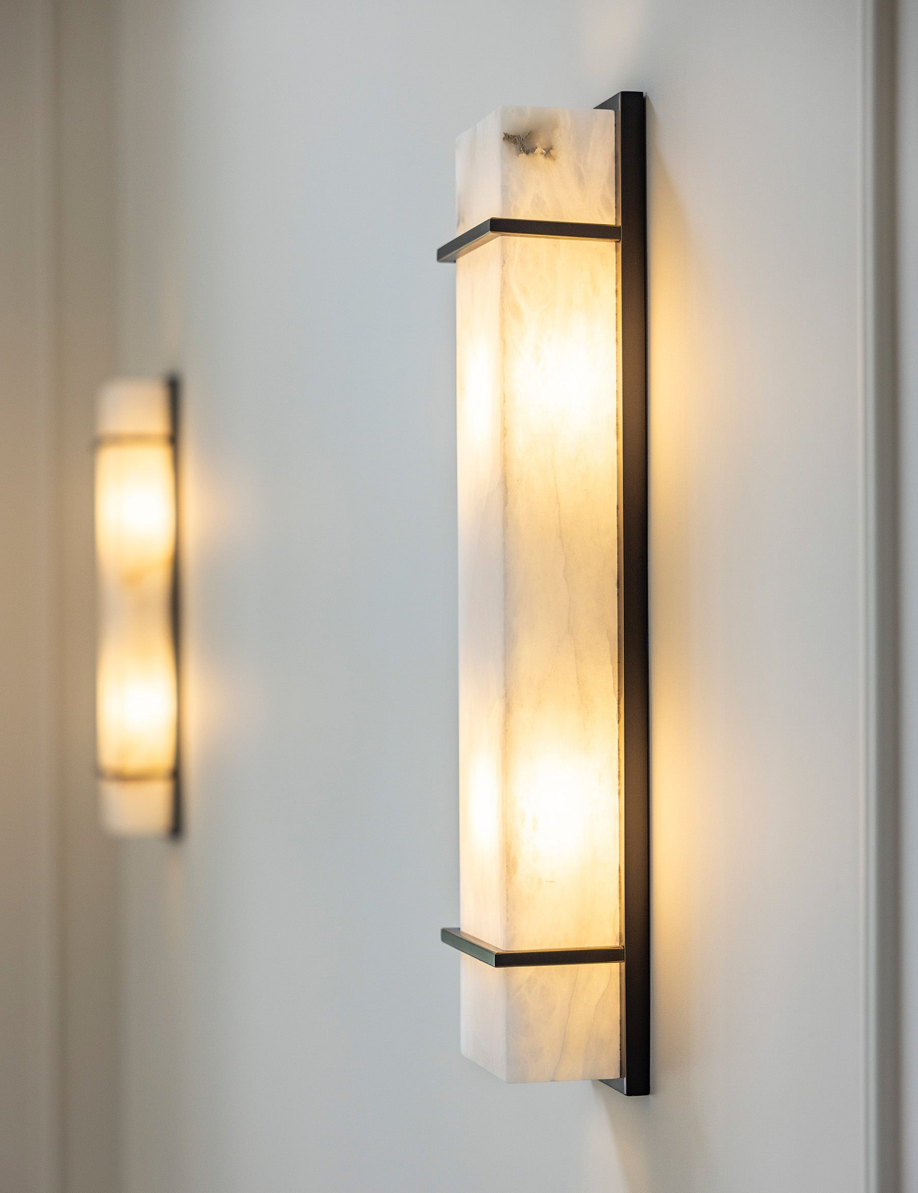 Modern marble wall sconce with warm ambient lighting for luxury interior design