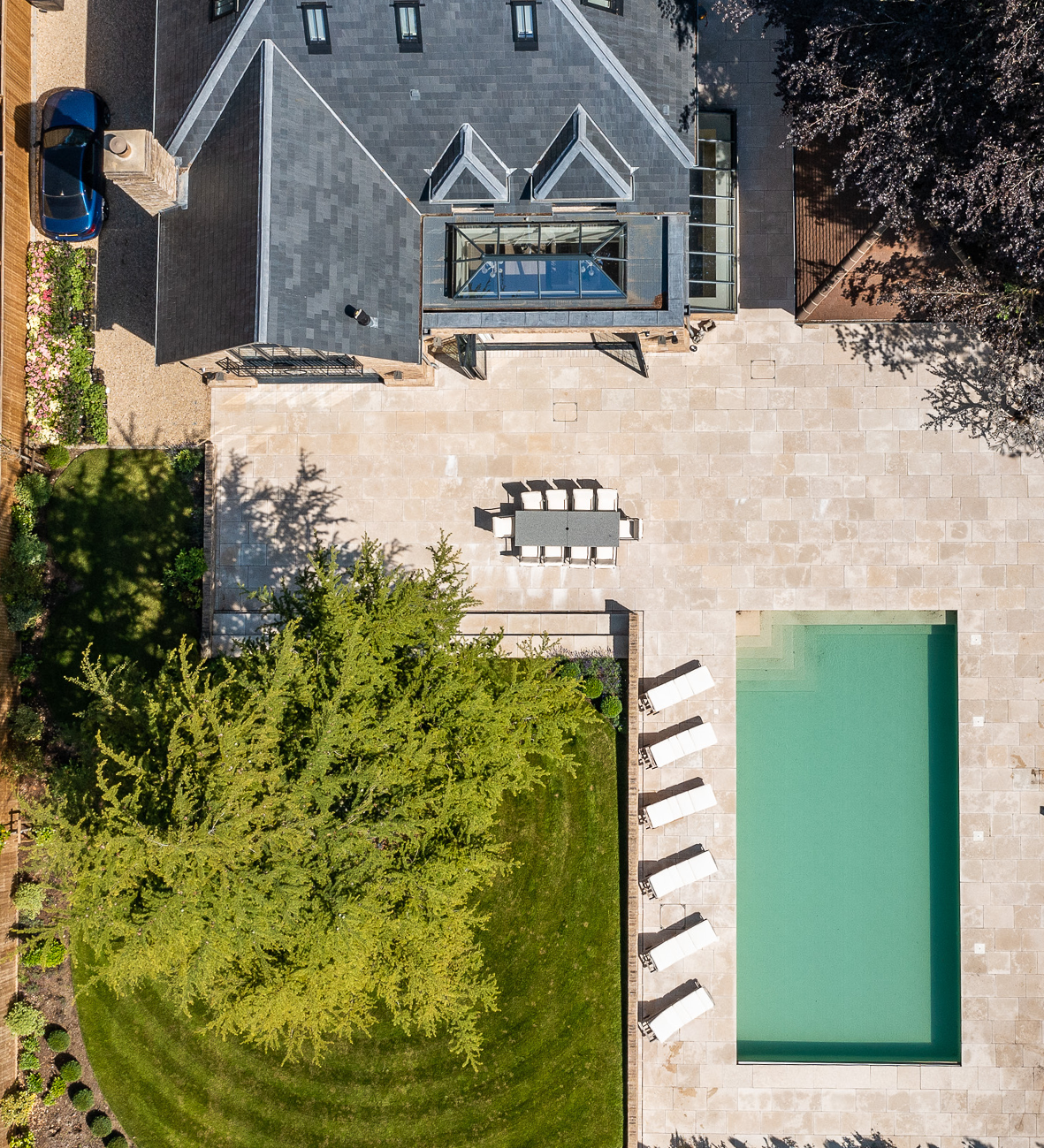Luxury home with pool, patio, and modern roof design for residential AV and lighting consultancy